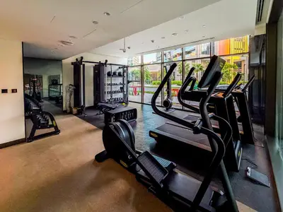 a gym with treadmills and ellipticals in a room at Escape24 Brand New 2BR with Canal Views near Burj Khalifa in Dubai