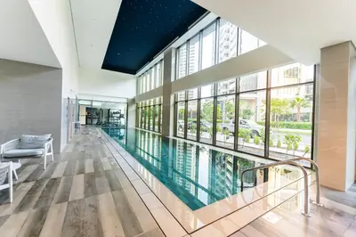 a swimming pool in a building with windows at Escape24 Brand New 2BR with Canal Views near Burj Khalifa in Dubai
