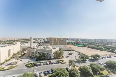 an aerial view of a building with a parking lot at Just Steps from the Community Center with Top-Tier Amenities, Minutes Walk to the Park, Hayat Boulevard 2A, Town Square by Deluxe Holiday Homes in Dubai