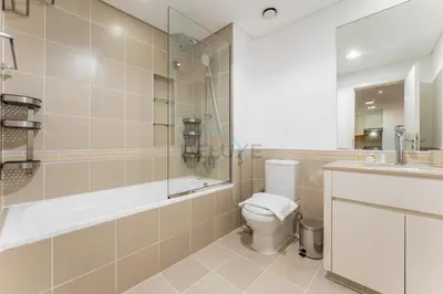 a bathroom with a toilet and a shower and a sink at Just Steps from the Community Center with Top-Tier Amenities, Minutes Walk to the Park, Hayat Boulevard 2A, Town Square by Deluxe Holiday Homes in Dubai