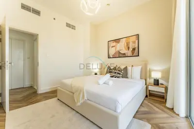 a bedroom with a large white bed in a room at Just Steps from the Community Center with Top-Tier Amenities, Minutes Walk to the Park, Hayat Boulevard 2A, Town Square by Deluxe Holiday Homes in Dubai