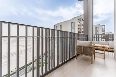 a balcony with a couch and a view of the beach at Community View, Near Dubai Creek Harbour Marina Walk - Summer at Creek Beach Building 2 by Deluxe Holiday Homes in Dubai