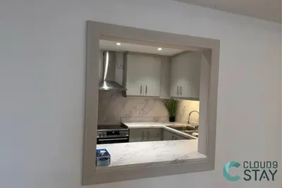 a view of a kitchen through a window at Cloud 9 - Steps to the Beach Elegant 2BR in JBR in Dubai