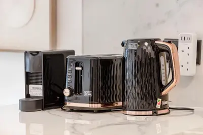 three toasters sitting on top of a counter at Chic 2BR Haven in Prime Location in Gardenia Living in Dubai