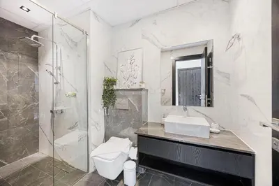 a bathroom with a toilet and a sink and a shower at Chic 2BR Haven in Prime Location in Gardenia Living in Dubai