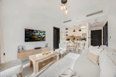 a living room with a couch and a table at Chic 2BR Haven in Prime Location in Gardenia Living in Dubai