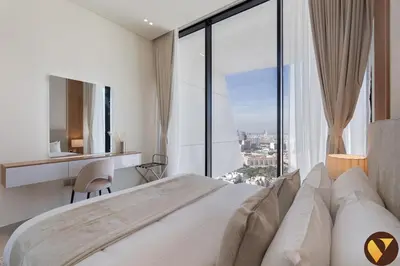 a bedroom with a large bed and a large window at Vogue JVC Binghatti Phantom near Circle Mall, One Bedroom Apartment with Large Balcony and City View, Access to all Amenities in Dubai
