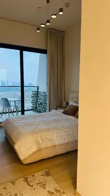 a bedroom with a bed and a view of the ocean at Kats in Dubai