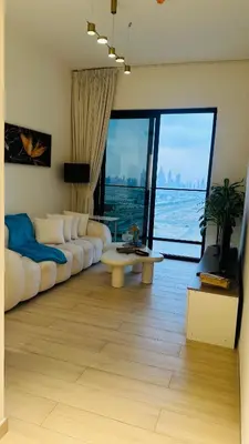 a living room with a white couch and a table at Kats in Dubai