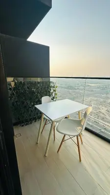 a white table and two chairs on a balcony at Kats in Dubai