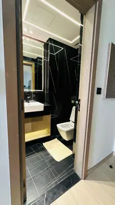 a bathroom with a toilet and a sink and a mirror at Kats in Dubai