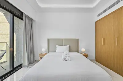 a bedroom with a large white bed and a window at Zafir Studio in Dubai by beBalmy in Dubai
