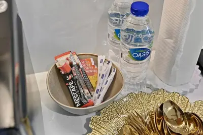 a table with a bowl of toothpaste and a bottle of water at Zafir Studio in Dubai by beBalmy in Dubai