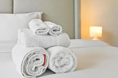 a pile of towels sitting on top of a bed at Zafir Studio in Dubai by beBalmy in Dubai