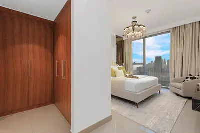 a bedroom with a bed and a large window at Keylid Stunning3BR and Maid connected to Dubai Mall in Dubai