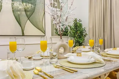 a dining room table with glasses of orange juice at Keylid Stunning3BR and Maid connected to Dubai Mall in Dubai