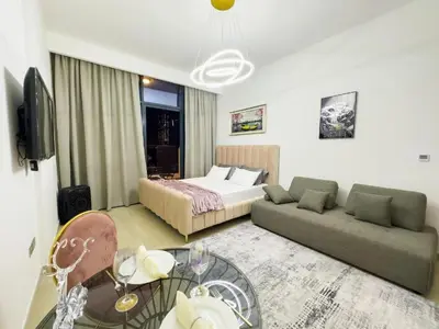 a hotel room with a bed and a couch at Dubai aziIzi in Dubai