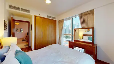 a bedroom with a large bed and a mirror at 2 bedroom JLT with park view in Dubai