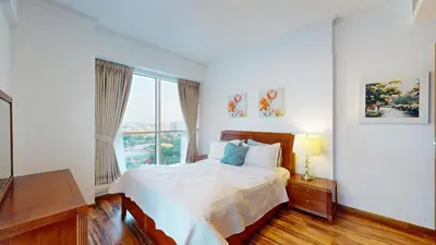 a bedroom with a bed and a large window at 2 bedroom JLT with park view in Dubai