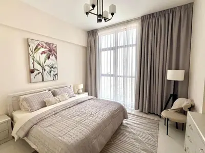 a white bedroom with a bed and a large window at 1BR Amazing Burj And Dubai View in Dubai