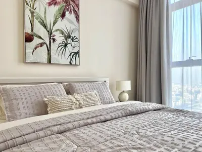 a bedroom with a large bed and a window at 1BR Amazing Burj And Dubai View in Dubai