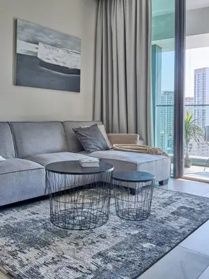 a living room with a couch and two tables at Amazing 1BR Address Beach Resort With Private Beach in Dubai