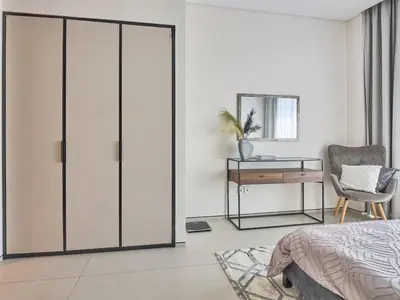 a bedroom with a sliding glass door with a desk at Amazing 1BR Address Beach Resort With Private Beach in Dubai