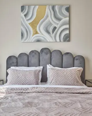 a bed with two pillows and a painting above it at Amazing 1BR Address Beach Resort With Private Beach in Dubai