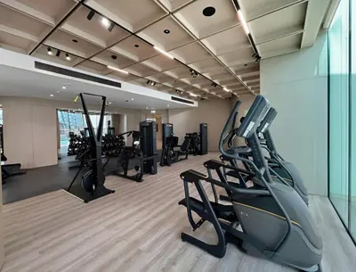 a gym with treadmills and ellipticals in a room at New 1BR with Private Pool Near Circle Mall in Dubai