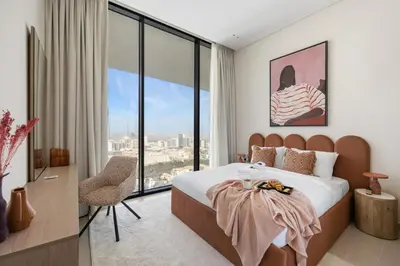 a bedroom with a bed and a large window at New 1BR with Private Pool Near Circle Mall in Dubai