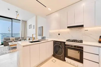 a kitchen with a stove and a dishwasher at Cozy 1BR Retreat in Binghatti Amber JVC in Dubai