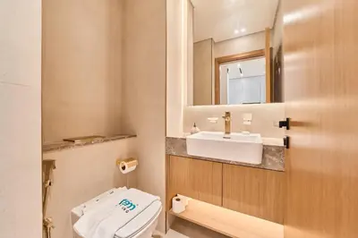 a bathroom with a toilet and a sink at Cozy 1BR Retreat in Binghatti Amber JVC in Dubai