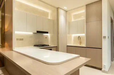 a kitchen with white cabinets and a counter top at Royale Family Apartment 281 with Plunge Pool in Dubai