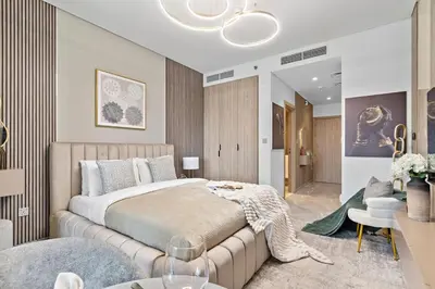 a bedroom with a large bed and a living room at The Smart Concierge - Peninsula One in Dubai