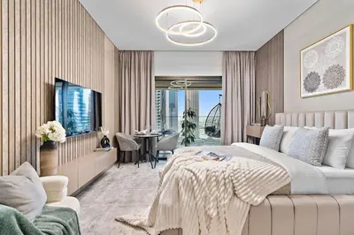 a bedroom with a large bed with a chandelier at The Smart Concierge - Peninsula One in Dubai
