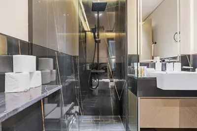 a bathroom with a shower and a sink at Cozy City-View Studio w Balcony & Queen Bed in Dubai