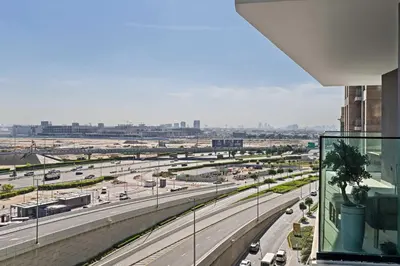 a view of a highway from a building at Cozy City-View Studio w Balcony & Queen Bed in Dubai