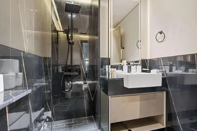 a bathroom with a sink and a shower at Cozy City-View Studio w Balcony & Queen Bed in Dubai