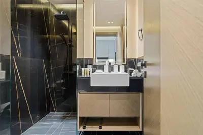a bathroom with a sink and a mirror at Cozy City-View Studio w Balcony & Queen Bed in Dubai