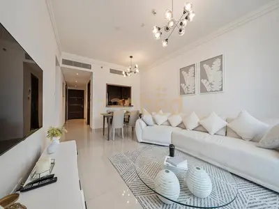 a living room with a white couch and a table at Zapbed House Luxury 2BR at Boulevard Point Walk to Dubai Mall in Dubai
