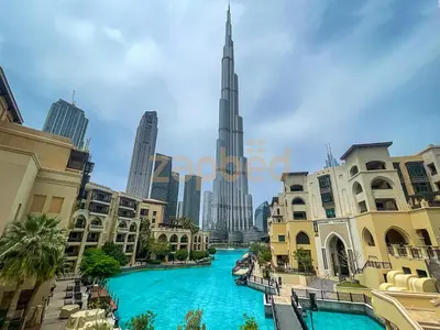 a view of the burj khalifa from a shopping mall with blue water at Zapbed House Luxury 2BR at Boulevard Point Walk to Dubai Mall in Dubai