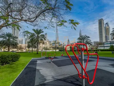 a park with a red bike rack in a city at Zapbed House Luxury 2BR at Boulevard Point Walk to Dubai Mall in Dubai