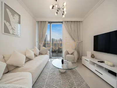 a living room with a couch and a flat screen tv at Zapbed House Luxury 2BR at Boulevard Point Walk to Dubai Mall in Dubai