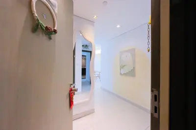 a hallway with a door with areath on the wall at Premium Burj Khalifa View Downtown Dubai in Dubai