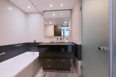 a bathroom with a sink and a tub and a mirror at Premium Burj Khalifa View Downtown Dubai in Dubai