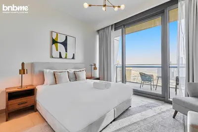 a bedroom with a large white bed and a large window at bnbmehomes - Burj Vista Tower 1 in Dubai