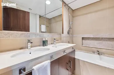 a bathroom with a sink and a mirror and a tub at bnbmehomes - Burj Vista Tower 1 in Dubai