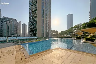 a large swimming pool in a city with tall buildings at bnbmehomes - Burj Vista Tower 1 in Dubai