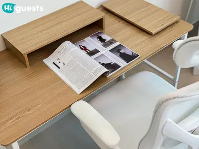 a wooden table with a newspaper on top of it at HiGuests - Family Friendly 1BR Near Burj Khalifa in Dubai