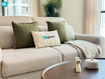 a couch with pillows and a coffee table in a living room at HiGuests - Family Friendly 1BR Near Burj Khalifa in Dubai